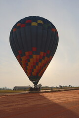 Colorful hot air manned balloon at sunrise 