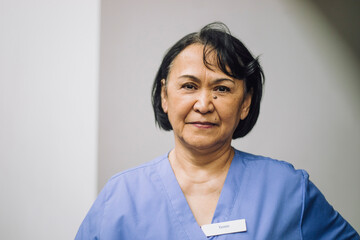 Portrait of confident female medical expert at hospital