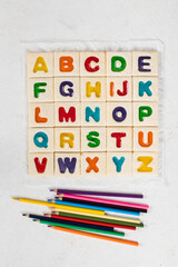 Children English Alphabet. Colored English letters. With colored pencils. Top view	