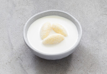 Milk soup with sweet cottage cheese quenelles. Close up