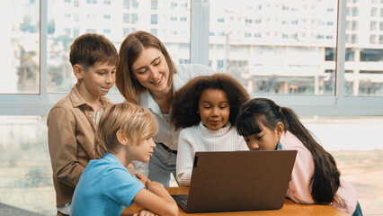 Cute african girl programing system while surround with caucasian teacher and diverse friend....