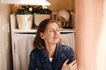 Smiling senior woman with medium length hair at home