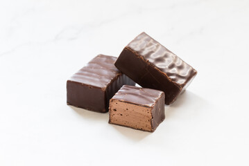 Vegan Chocolate bird's milk. Chocolate souffle in chocolate glaze. White background. Close-up
