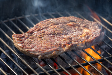 steak grilling on charcoal grill