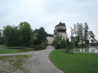 Obraz premium Blatna historical Gothic medieval water castle with towers and turrets, plus extensive grounds home to fallow deer and a cafe. 