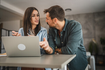 Adult woman work from home while her boyfriend hug and stand with her