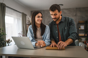 Adult woman work from home while her boyfriend hug and stand with her