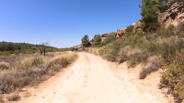 Camino del Ebro of Saint James - a dirt road on a summer landscape next to Caspe, province of Zaragoza, Aragon, Spain