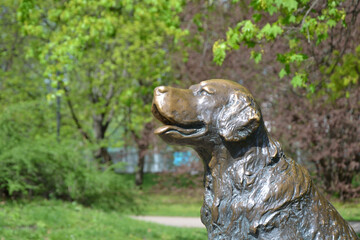 Warsaw, Poland. Dog statue. Warm, spring day at Mokotow Field (Polish: Pole Mokotowskie) - a large park complex.