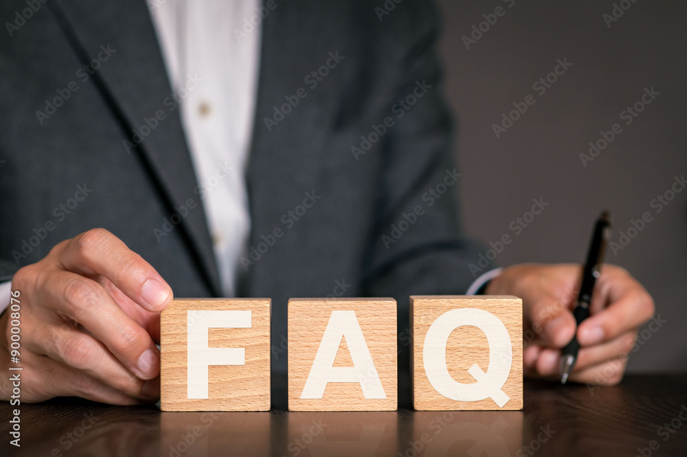 Poster there is wood cube with the word faq. it is an abbreviation for frequently asked questions as eye-ca
