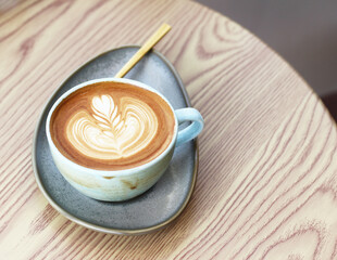 Hot cappuccino latte coffee cup on a table in a coffee shop