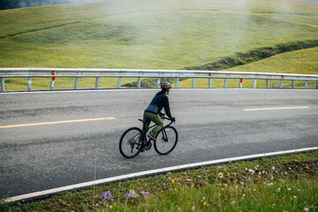 Riding bike on grassland mountain top trail