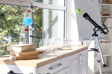 Chemical glassware with books on counters in laboratory