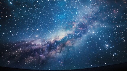 The ceiling of a planetarium dome illuminated with a projection of the Milky Way.