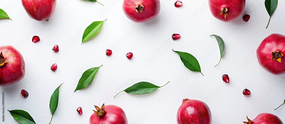 Poster isolated pomegranate with leaves on a white background offering copy space image seen from above in 
