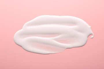 Sample of face cream on pink background, top view