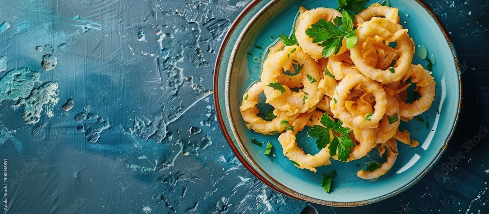 Poster copy space image of a plate with mediterranean style calamari rings battered squid fried briefly on 