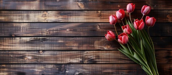 Tulip bouquet displayed on a wooden backdrop with a copy space image