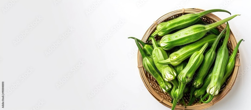 Leinwandbilder raw okra in a basket isolated on a white background with horizontal orientation and space for text o
