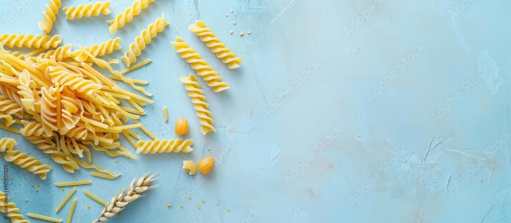Aufkleber Trofie pasta uncooked on a light blue backdrop top down view with copy space image
