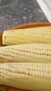 Vertical food video, cooked corn to prepare mexican elotes
