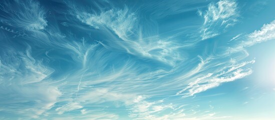 Obraz premium A serene scene of clear blue skies with wispy white clouds peacefully drifting in the airy atmosphere creating a tranquil copy space image