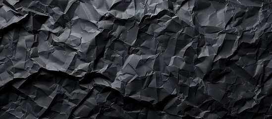 Crumpled black paper textures providing a copy space image