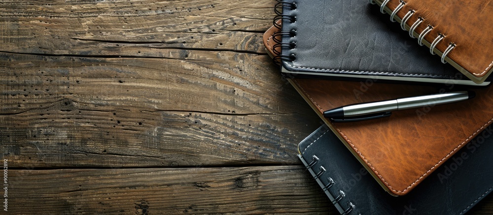 Poster Business concept displayed with notebooks and a pen arranged neatly on a wooden table emphasizing professionalism and creativity in the copy space image