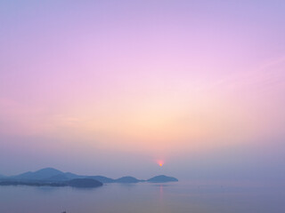 Aerial view stunning the golden sun shining above the island..Scene of colorful reflection on the sea surfect. sweet sky cover the ocean..Gradient color. Sky texture, abstract nature background..