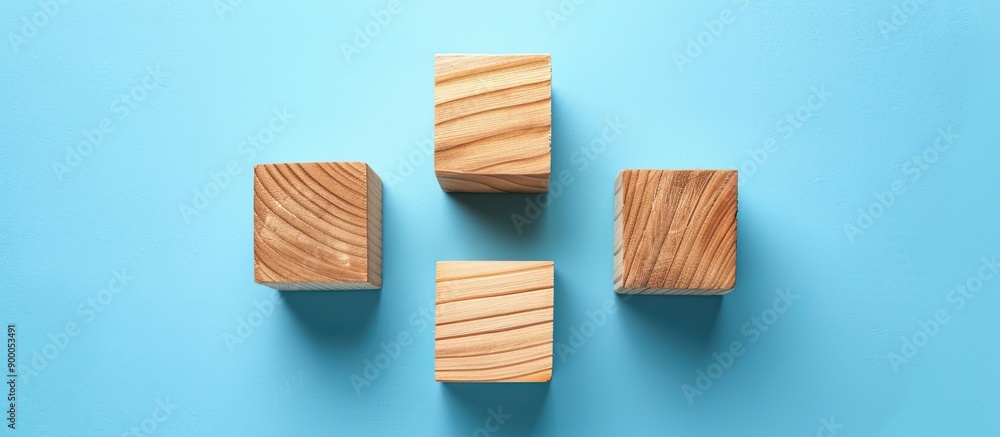 Poster A bird s eye view of three empty wooden cubes on a blue backdrop with copy space image