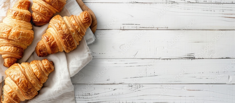 Aufkleber Top view of croissants presented on a white wooden board with ample copy space image