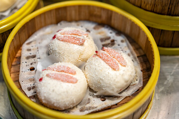 Delicious Steamed Dumplings in a Bamboo Basket with Unique Toppings