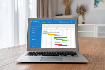 Fototapeta premium Project planning software for modish business project management on the computer screen showing timeline chart of the team project