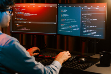 Working IT developer concentrating online software development information on surrounded by coding...