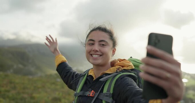 Woman, hiking and video call with talk, mountains and show location with smile, hello and adventure. Influencer girl, outdoor and happy on hill, fitness and wellness on holiday with social media post