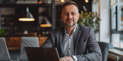 Fototapeta premium Successful Male Executive: Confident Businessman, Banker, or Financial Director at Office Desk. Professional Portrait with Laptop, Smiling at Camera. AI-Generated 4K Illustration Showcasing Corporate 