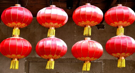 Ceiling hanging red paper Chinese lanterns against dark background