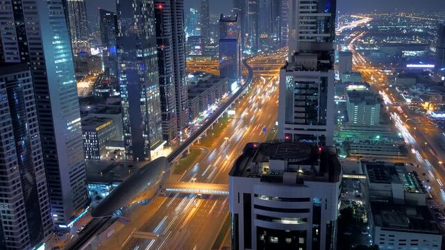 Night cityscape with lit buildings and blurred traffic lights in a vibrant urban landscape