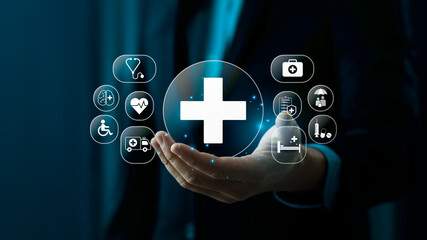 businessman holding a digital healthcare symbol with medical network icons represents online medical services, protection, and modern technological innovation. Representing Online Medical Protection