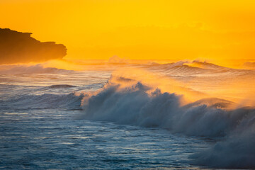 Wave breaking under the morning golden hour at Curl Curl Beach, Sydney, Australia.