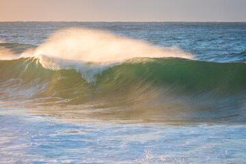 Fototapeta premium Close-up view of wave breaking with water spray.