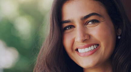 Smile, woman and portrait in nature for wellness, positive mindset and healthy on mockup space. Female person, happy and face in natural environment for summertime, peace and relaxing in Portugal
