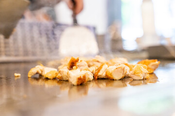 The chef is stirring the delicious Teppanyaki chicken and the aroma is overwhelming