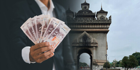 Businessman holding Lao kip The Lao Kip continues to depreciate. investment finance concept