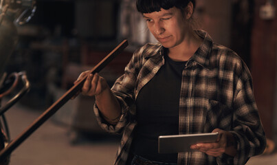 Woman, metal and tablet in workshop for equipment inspection, checklist and product specification....