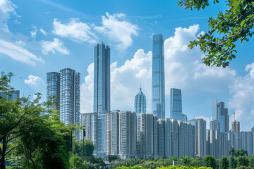 Fototapeta premium Skyscrapers Reaching into a Bright Blue Sky with White Clouds on a Sunny Day