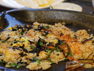 Korean fried rice after barbeque on the grill. Crispy bokkeumbob, crunchy rice with vegetables.