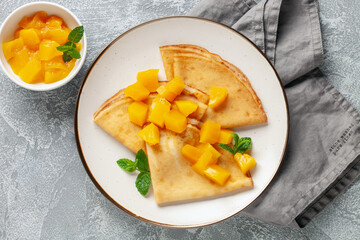 Crepes (Russian Blini) on grey background,. Homemade thin fresh crepes for breakfast or dessert....