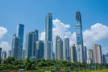 Fototapeta premium Skyscrapers Reaching into a Bright Blue Sky with White Clouds on a Sunny Day