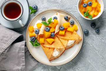 Crepes (Russian Blini) on grey background,. Homemade thin fresh crepes for breakfast or dessert....